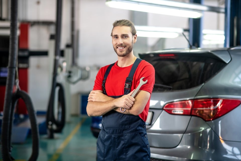 Service technician performing vehicle maintenance